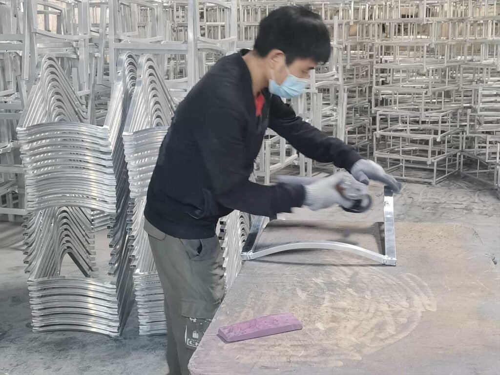 a worker is polishing aluminum frame