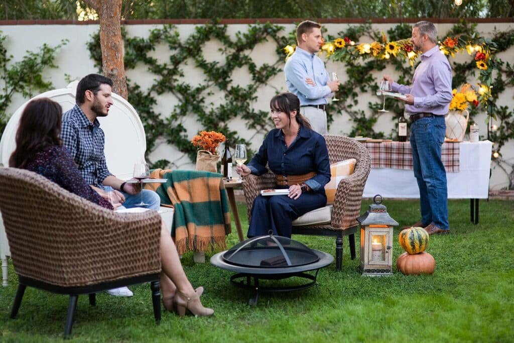 family chat sitting on patio furniture